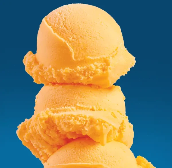 3 scoops of orange sherbet on a blue background