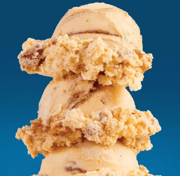 3 scoops of pumpkin pie ice cream on a blue background