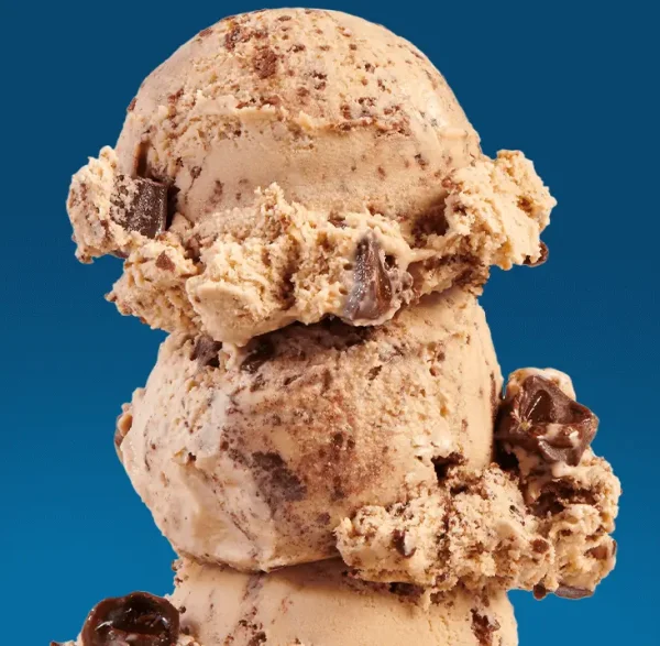 3 scoops of salty caramel ice cream on a blue background